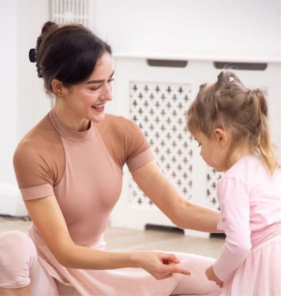 Hannah Lancaster teaching a young ballet student.